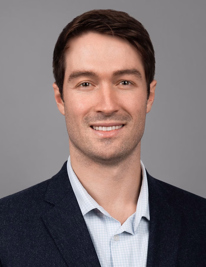 Confident headshot of NYC lawyer in studio