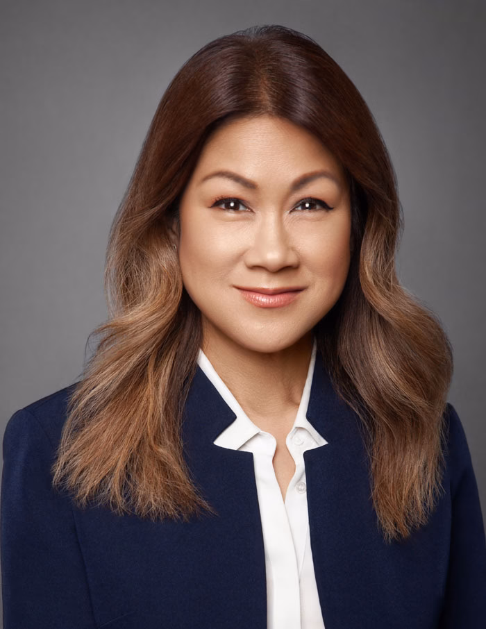 Business professional posing for a corporate headshot in a New York studio.