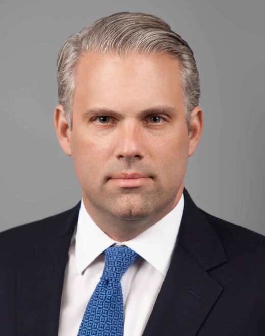 Professional LinkedIn headshot of a confident business professional in a New York City studio with clean lighting and modern background.