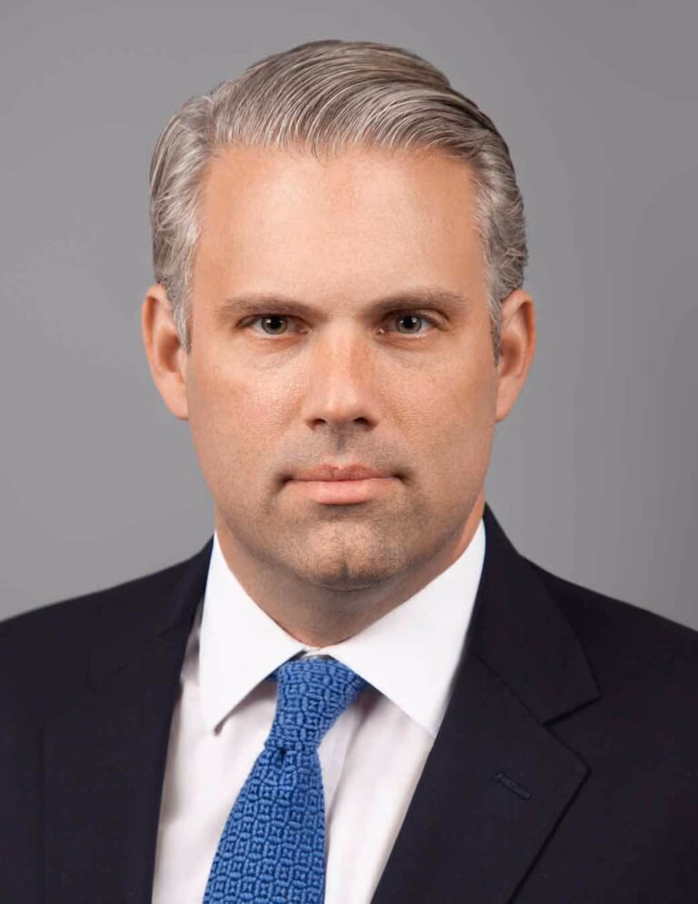 Professional LinkedIn headshot of a confident business professional in a New York City studio with clean lighting and modern background.