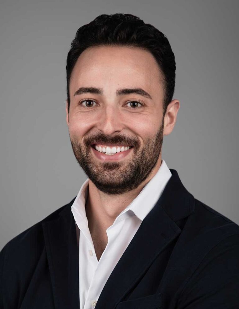 Corporate headshot photographer capturing a professional portrait in an NYC studio.